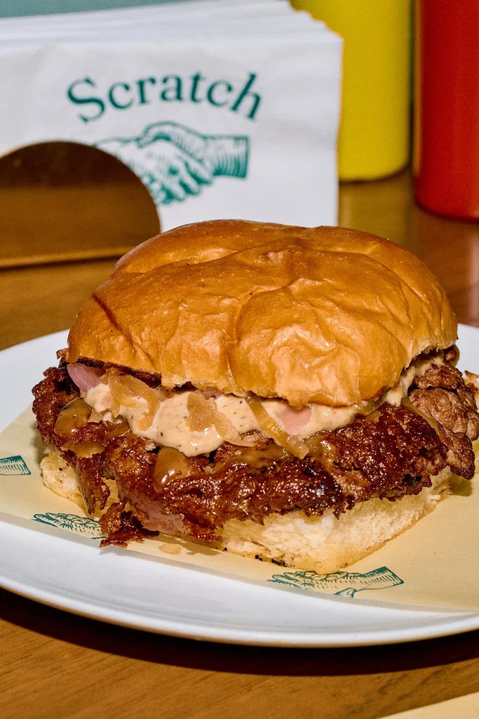 Burger with the Scratch branded tray sign