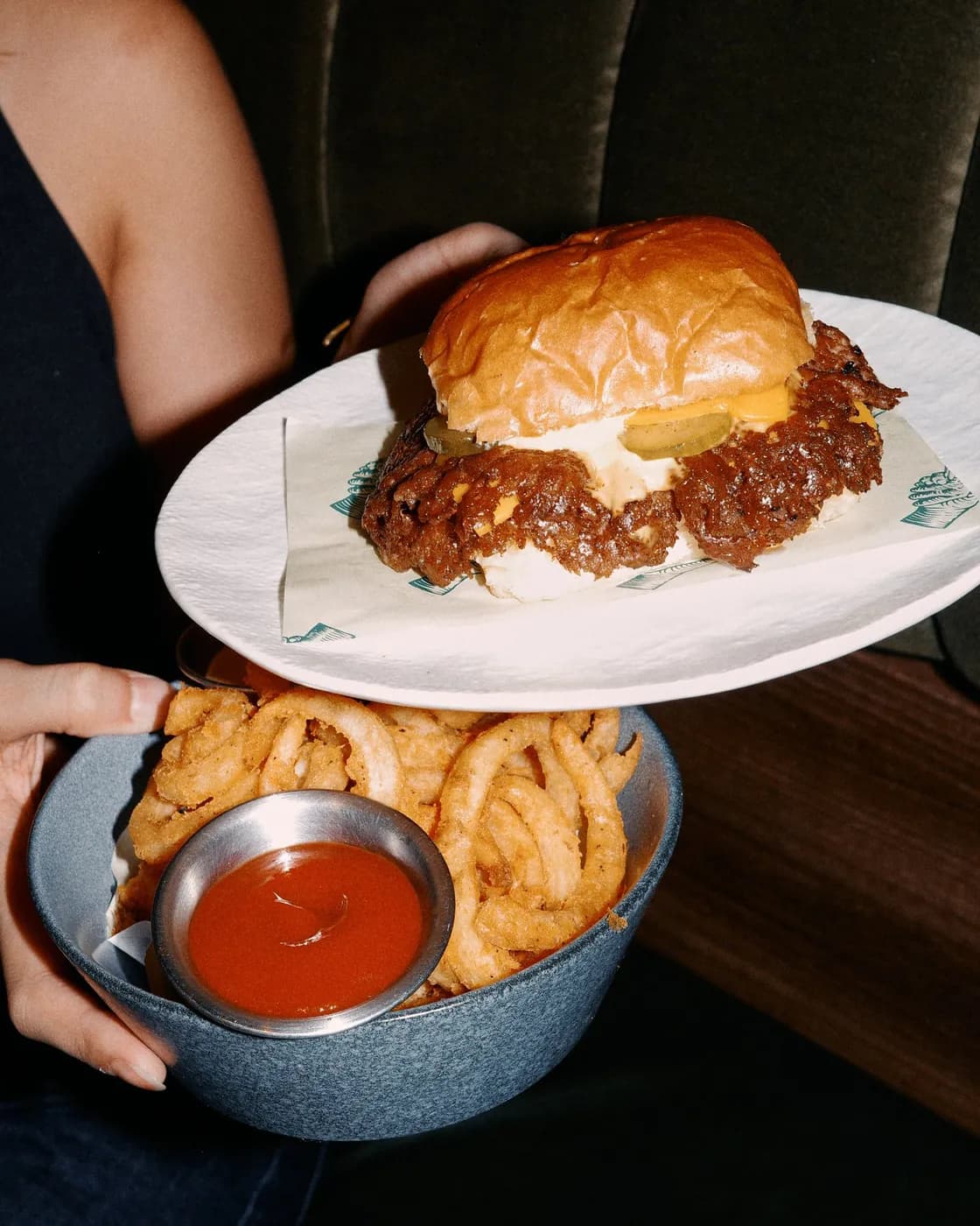Burger, fries, and dip being served