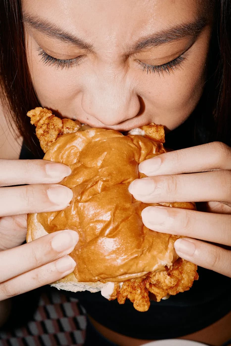 A bite of a hot chicken sandwich