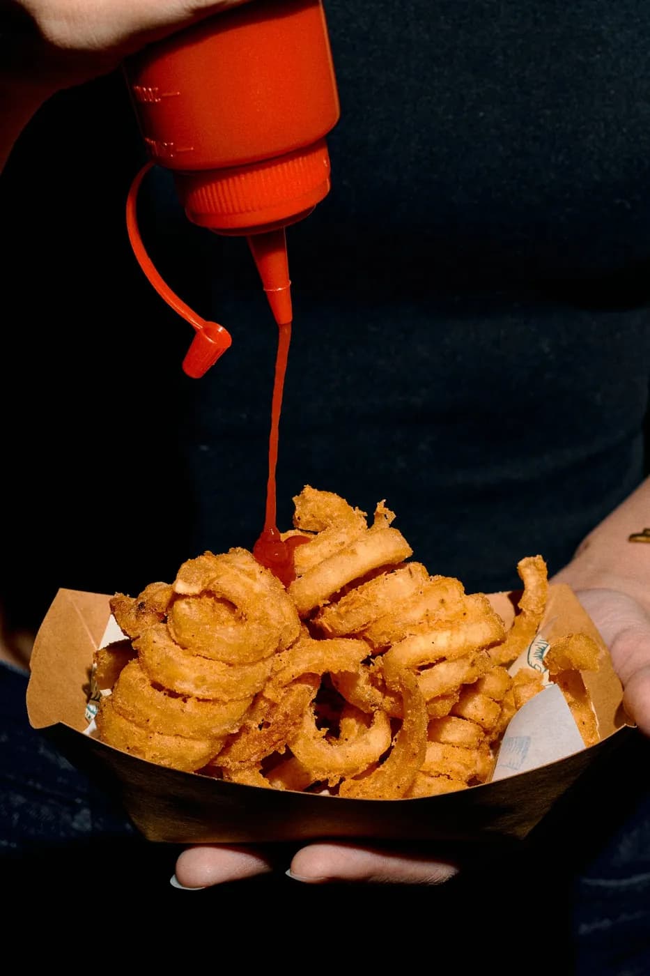 Ketchup poured over twister fries