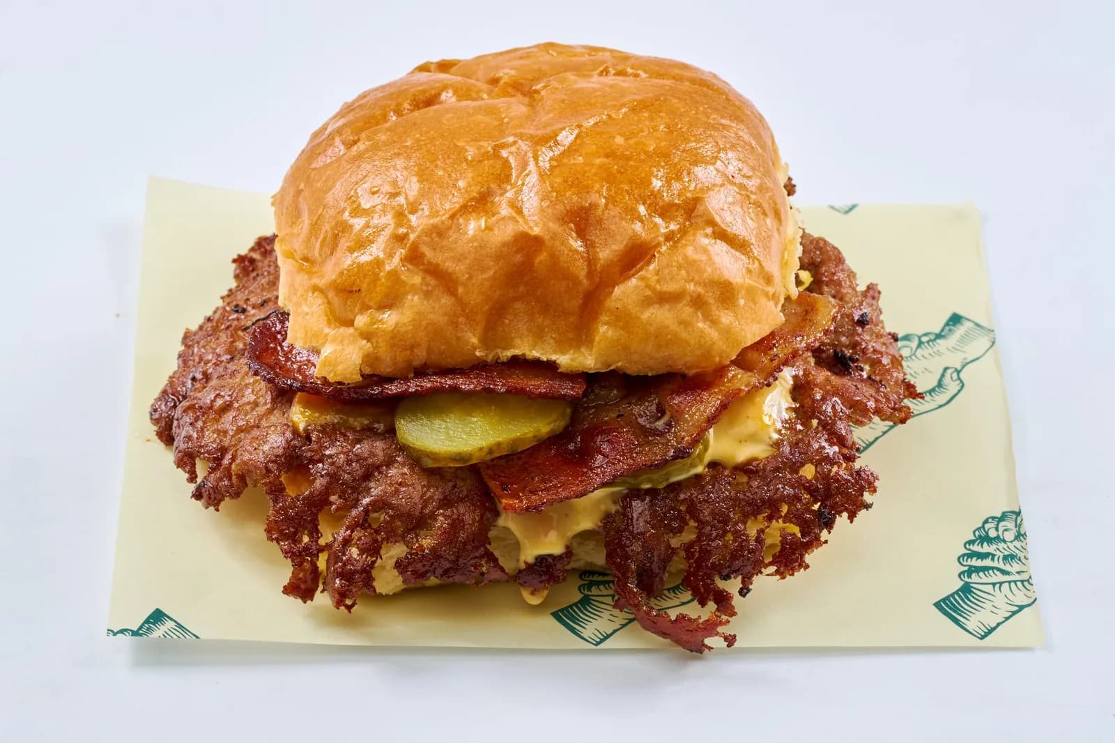 Bacon Smash Burger with cheddar and bacon on the cream Scratch wrapper