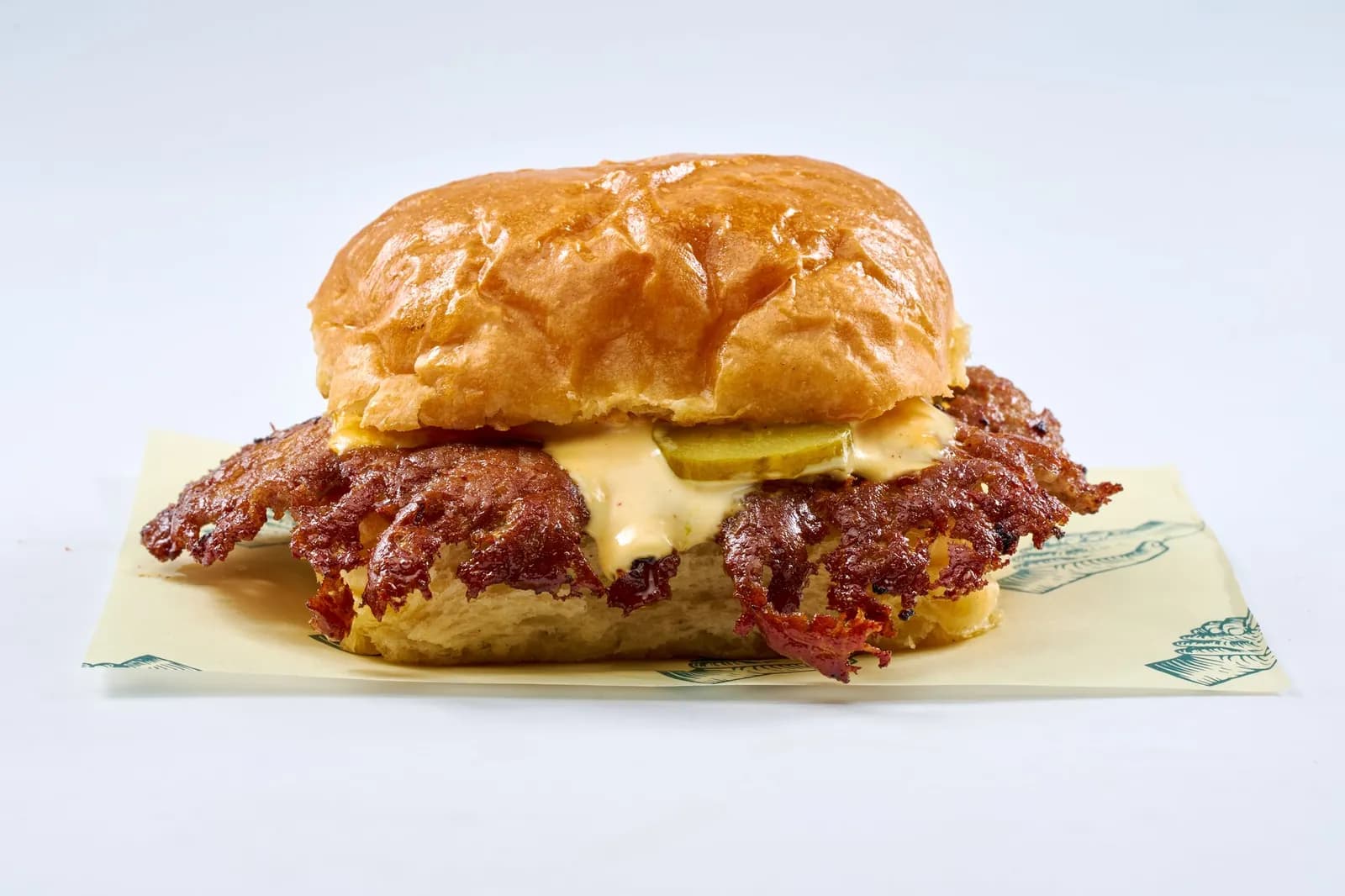 Smash Burger with cheddar and pickles on the cream Scratch wrapper