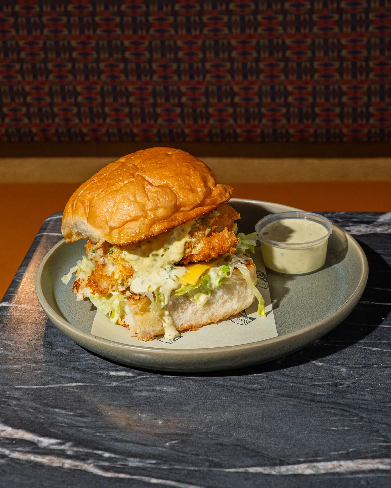 The Brooklyn Fishwich, a panko tilapia sandwich with tartar sauce on a potato bun