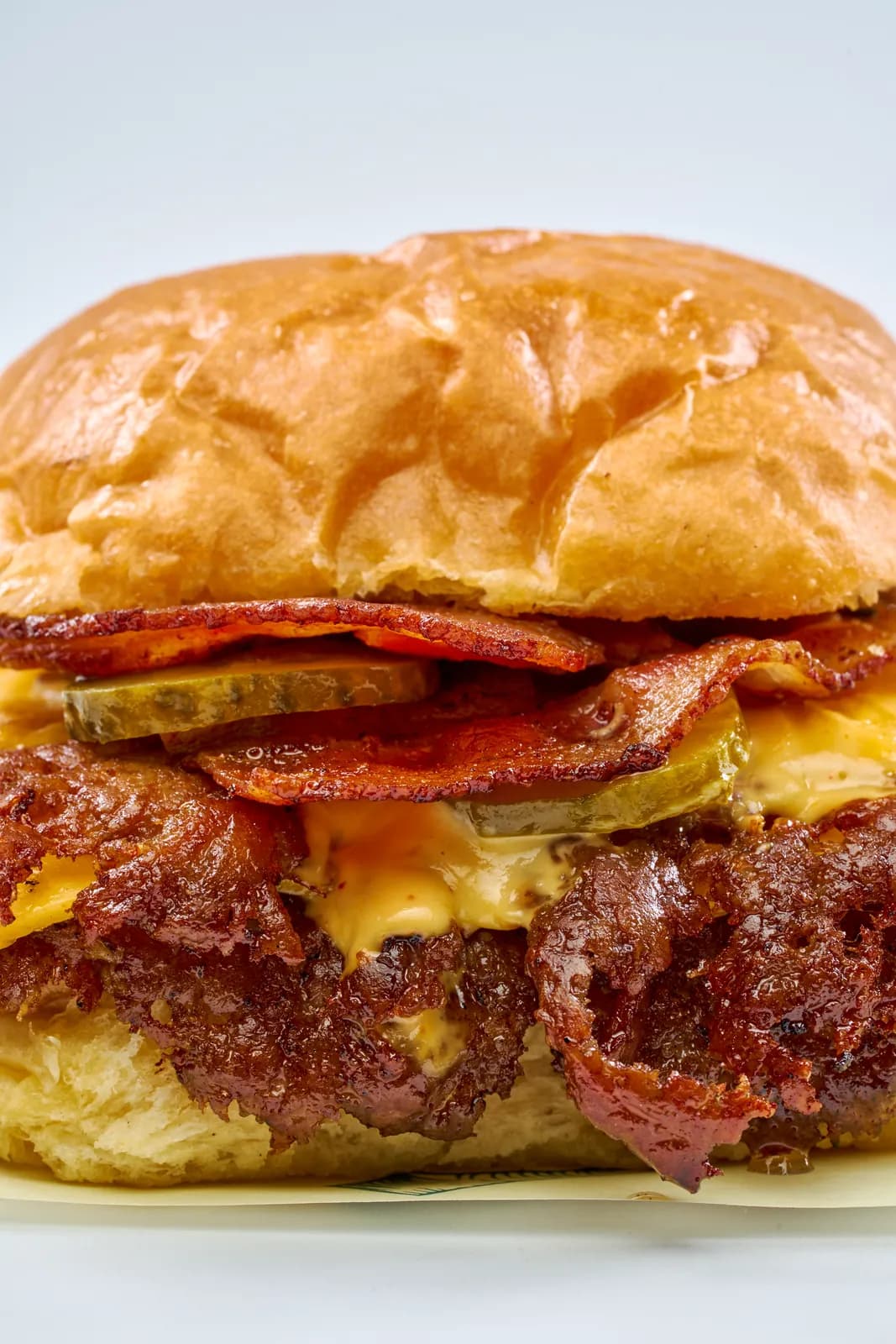 Close-up of a Bacon Smash Burger with cheddar and bacon